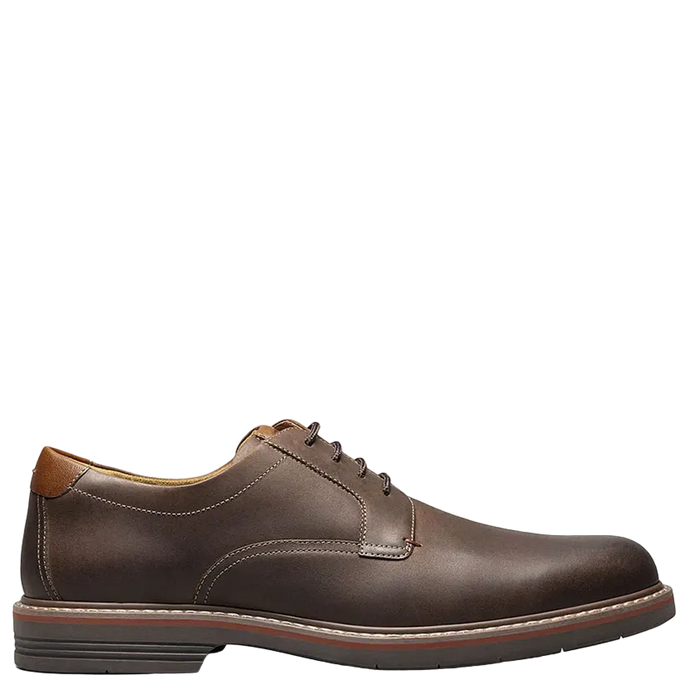 Brown leather dress shoe on a white background