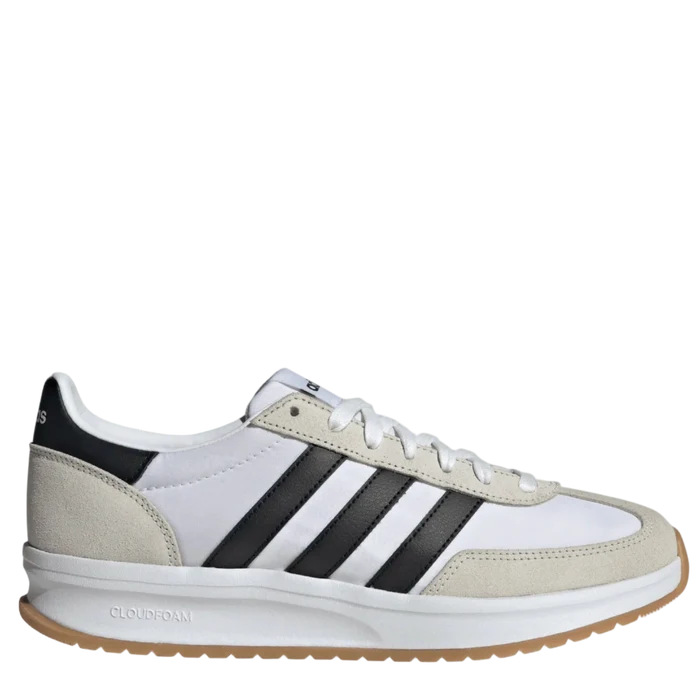 White sneaker with black stripes on a light gray background