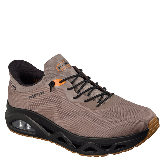 Brown hiking shoe with black sole on a white background