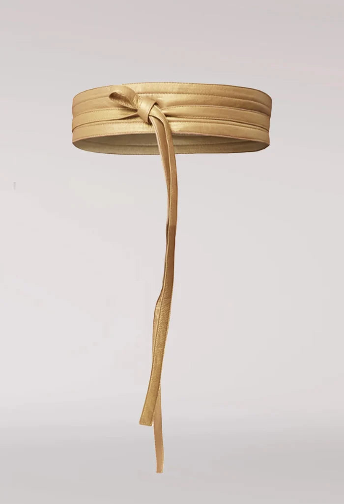 Gold belt with a bow on a light gray background. Once Was Milton Belt Gold.