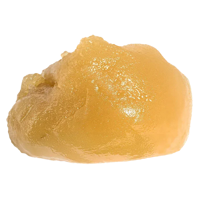 Close-up of a glossy golden dab of Niagara Nuken Jumbo Jar Rosin displayed on a white background, showing its smooth, slightly textured surface.