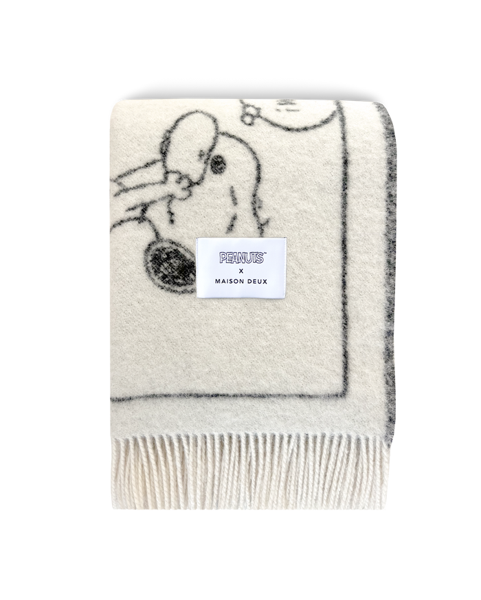 Maison Deux Peanuts comic strip wool blanket in white and black, folded