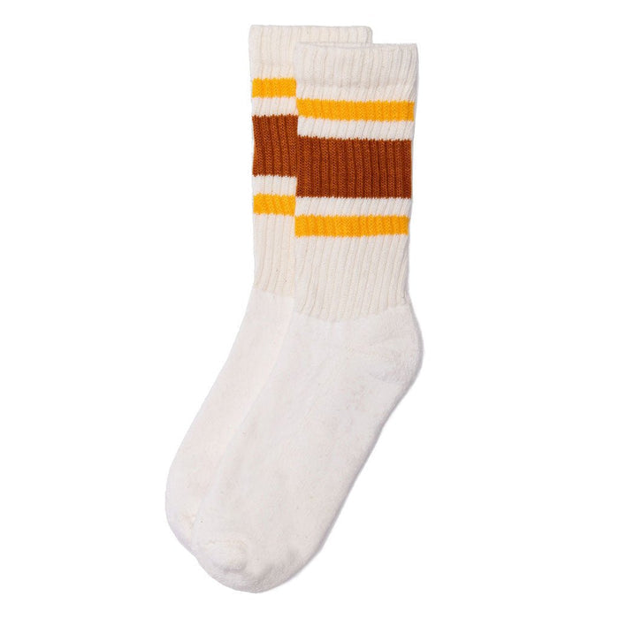 Pair of white ribbed crew socks with wide orange bands and gold stripes near the top