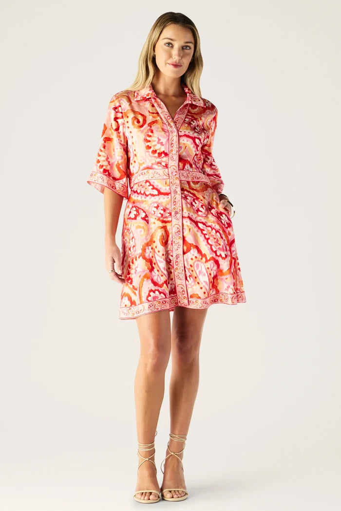 Woman wearing a patterned dress on a white background