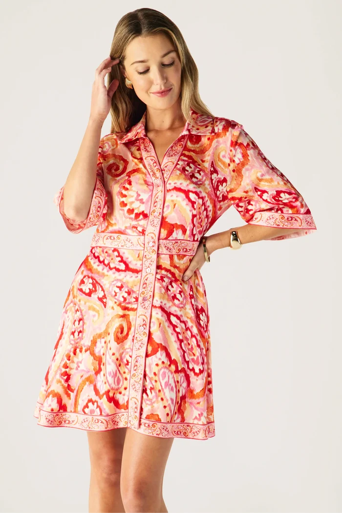 Woman wearing a colorful patterned dress on a white background