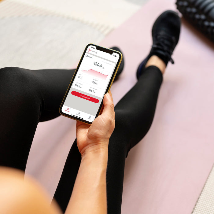 Smartphone screen shows body composition data from the Precision Hub app including weight 150.6 lb