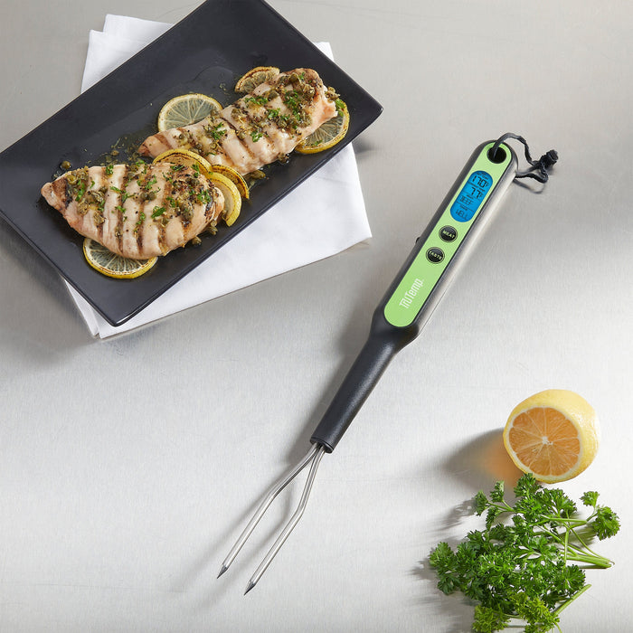 TruTemp Programmable Fork Thermometer beside plated fish with lemon slices and herbs