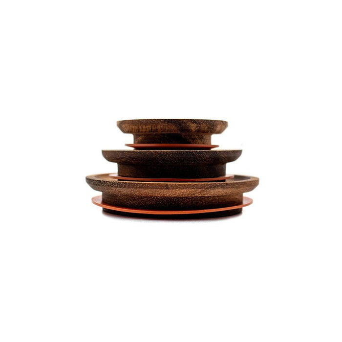 Stack of three wooden Weck Lids for glass jars on white background