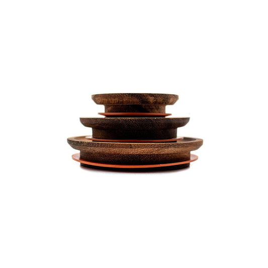 Stack of three wooden Weck Lids for glass jars on white background