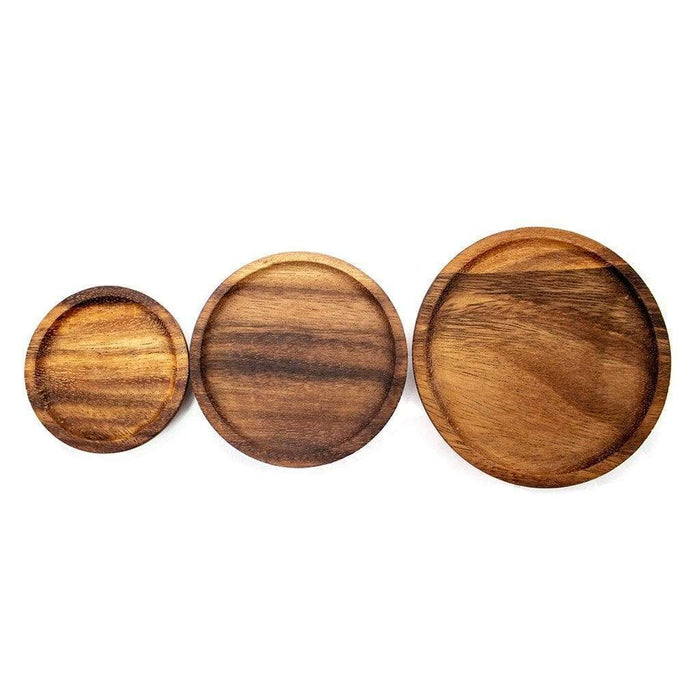 Three wooden lids in various sizes on white background