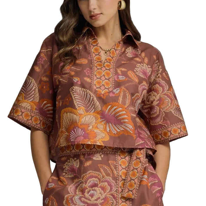 Woman wearing a patterned outfit on a gray background