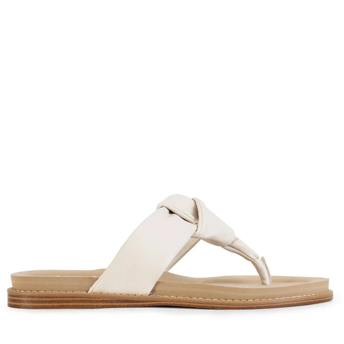 White sandal with a brown sole on a white background
