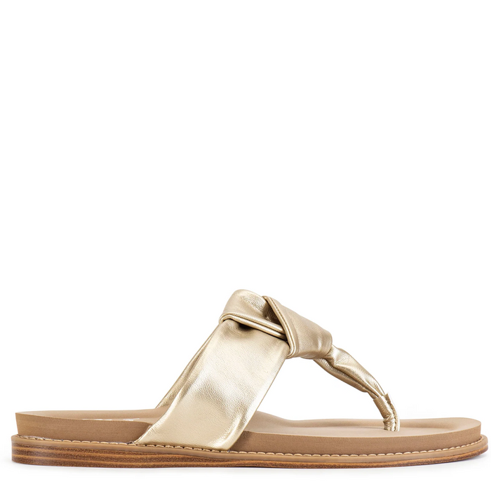 Gold sandal with a bow on a white background