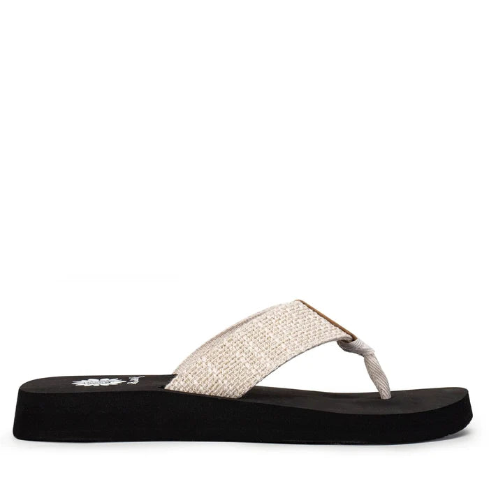 Black sandal with a white strap on a white background