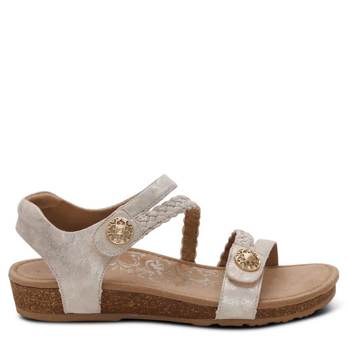 Beige sandal with brown sole on a white background