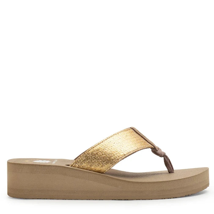 Gold sandal with a platform sole on a white background