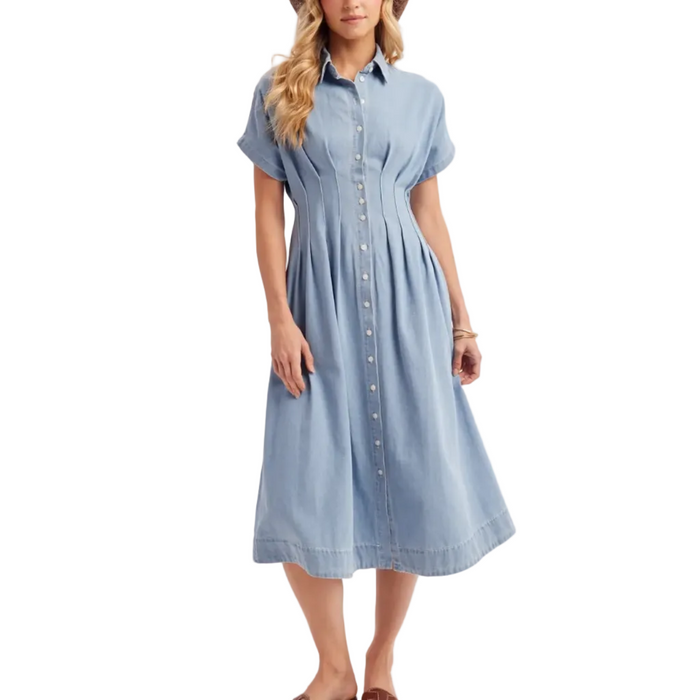 Woman wearing a light blue dress with a plain background