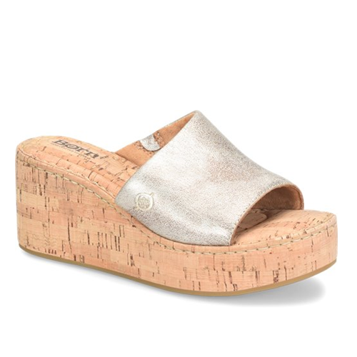 Wedge sandal with cork sole and metallic strap on a white background