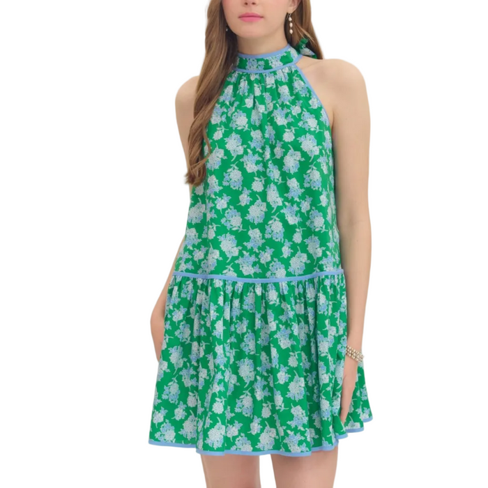 Woman wearing a green floral dress on a white background