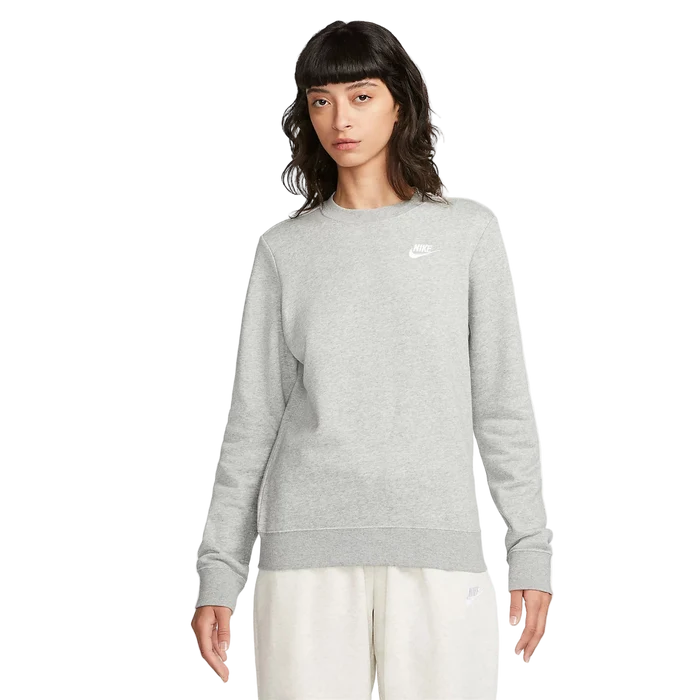 Woman wearing a gray Nike sweatshirt on a white background