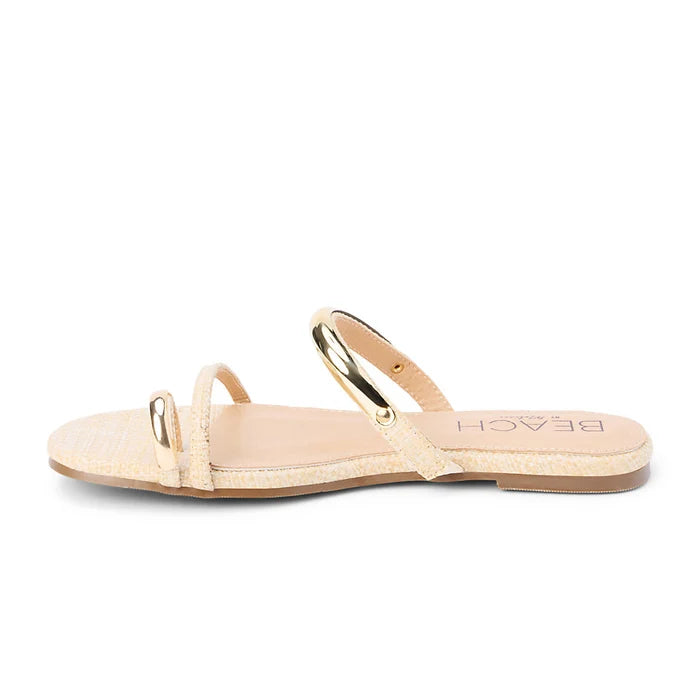 Beige sandal with gold straps on a white background