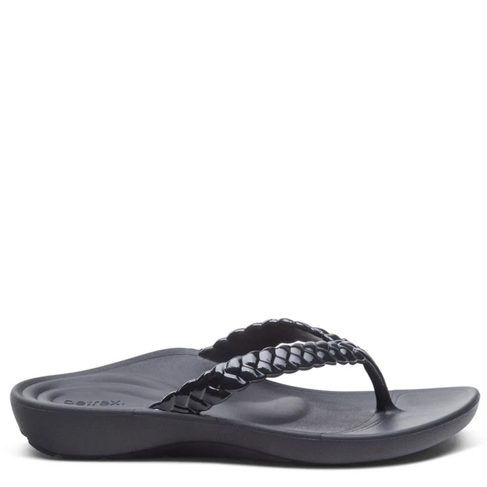 Black sandal with braided design on a white background