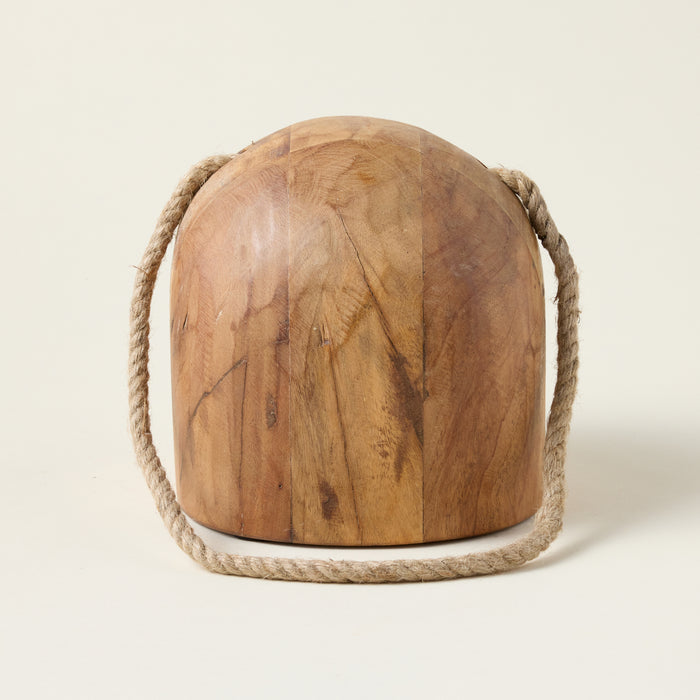 Salvaged wood doorstop with a geometric shape and a woven rope handle, styled with nautical charm.
